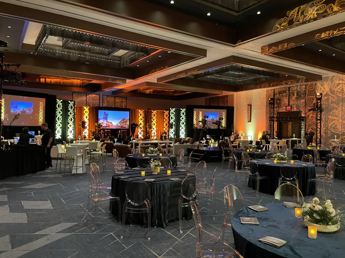 Dinner program setup with stage lighting and screens at JW Marriott Nashville