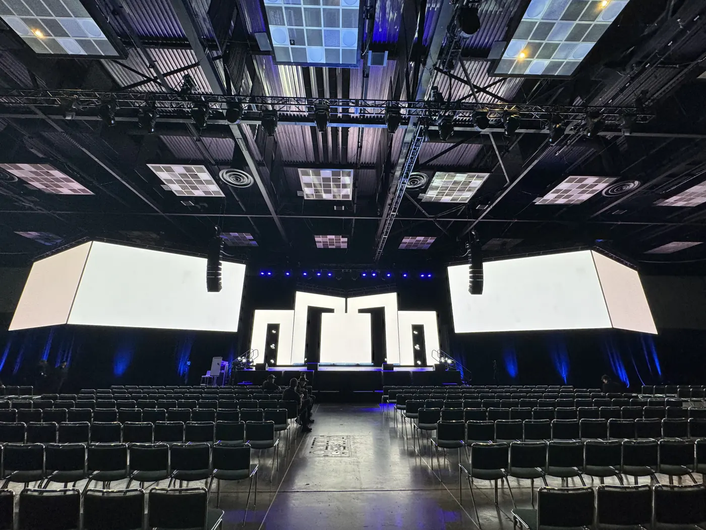 Rigged LED side screens and a center wall in an empty ballroom before the event
