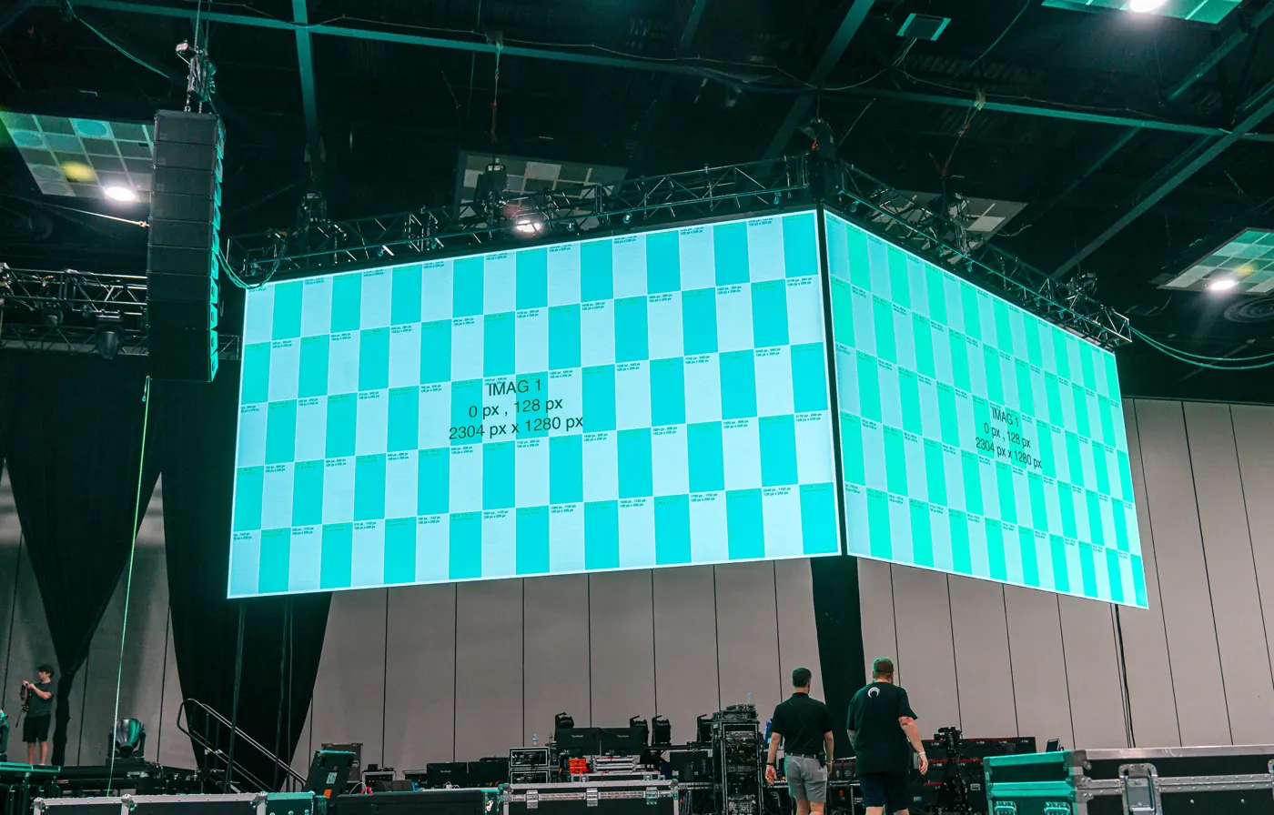 LED wall corner under a pixel test pattern during a convention center build