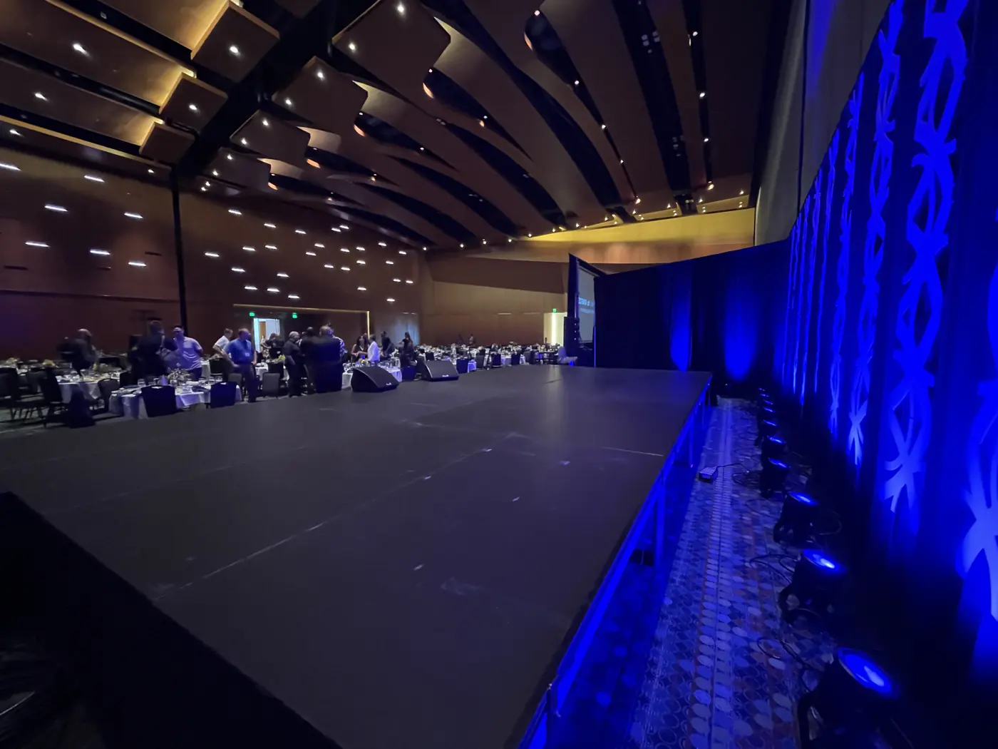Stage lighting and LED screens in the Music City Center ballroom